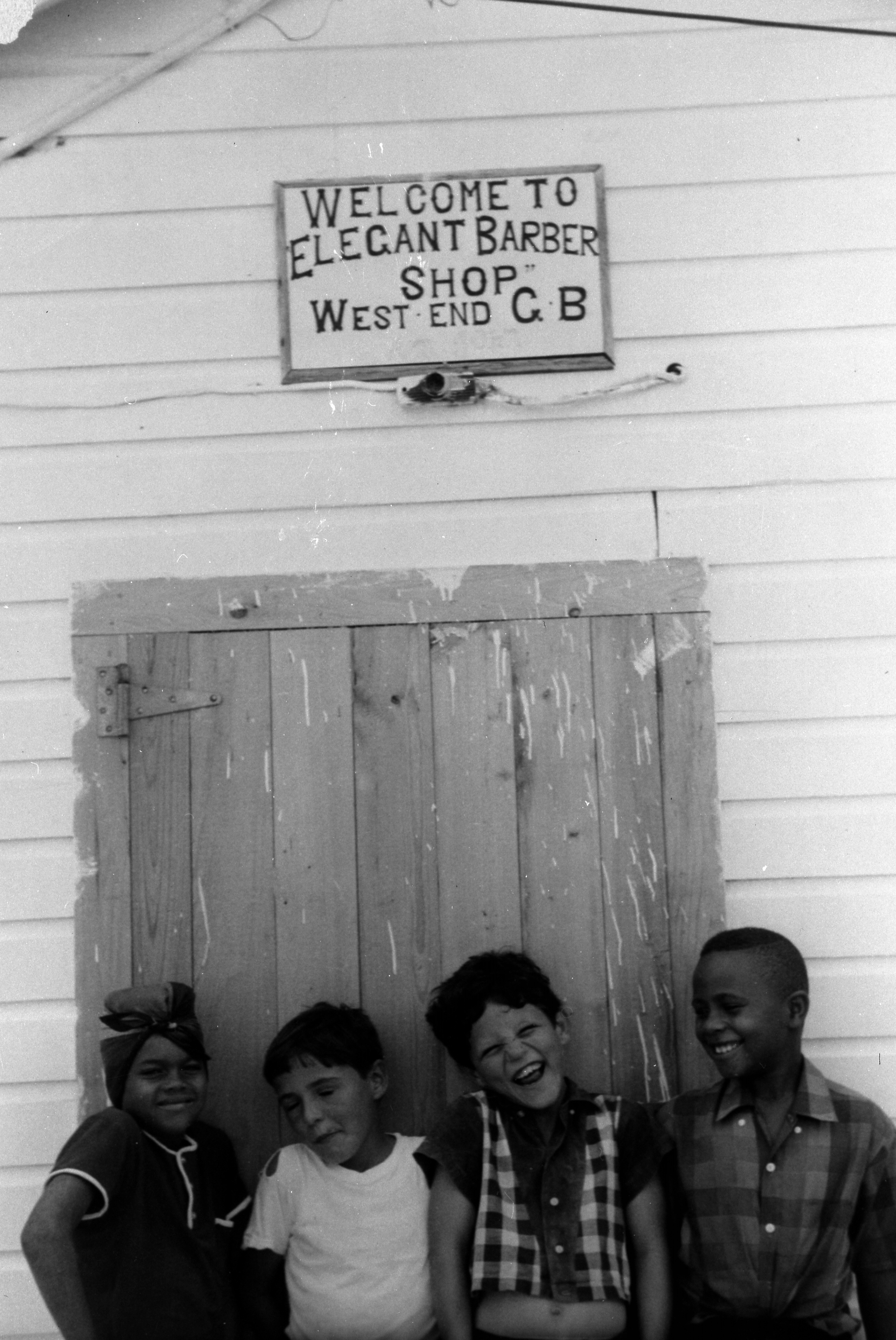 Children in front of West End barber shop