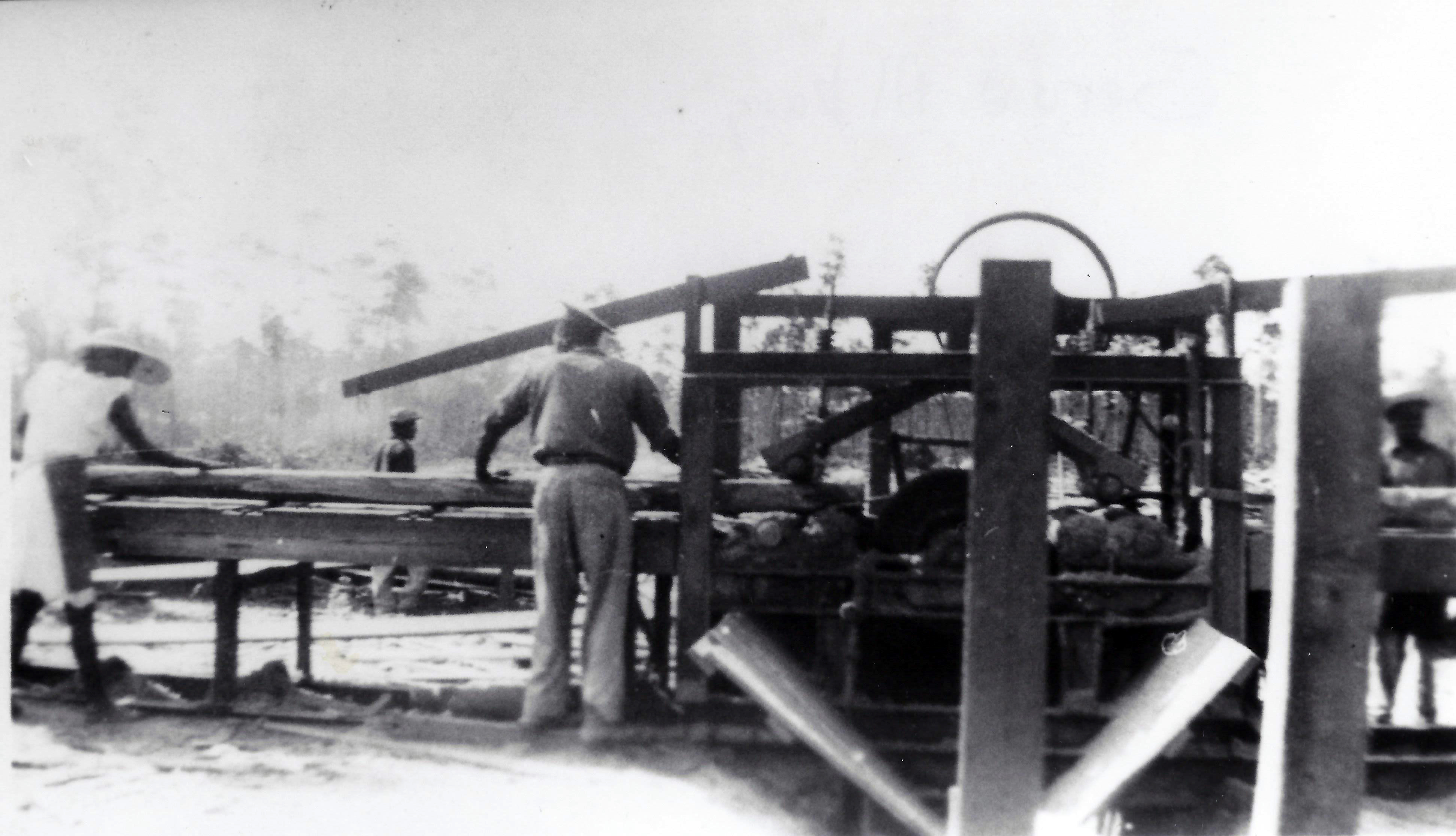 Guiding logs into the mill at Pine Ridge, 1950's